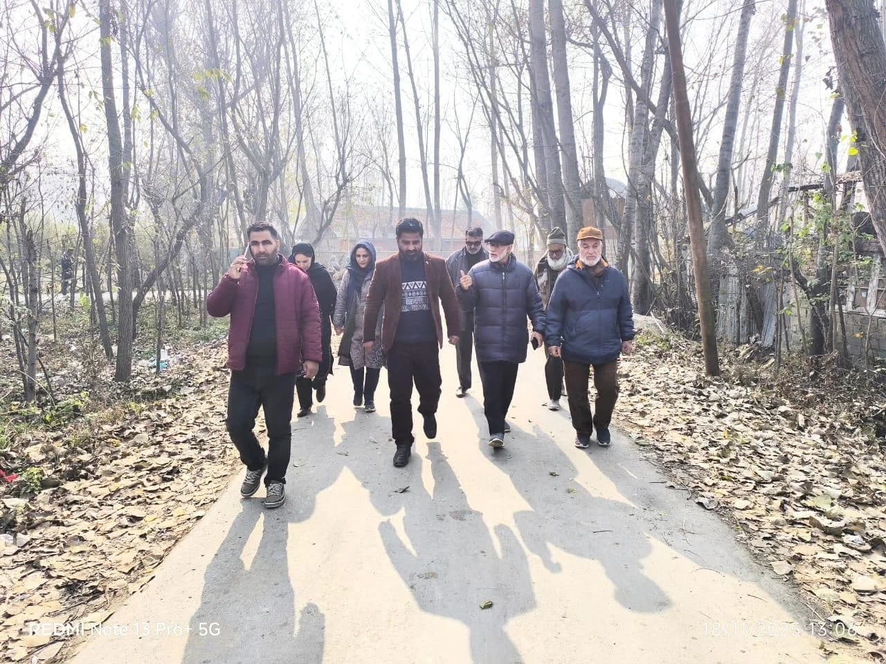 A group walking together through a village during a community visit