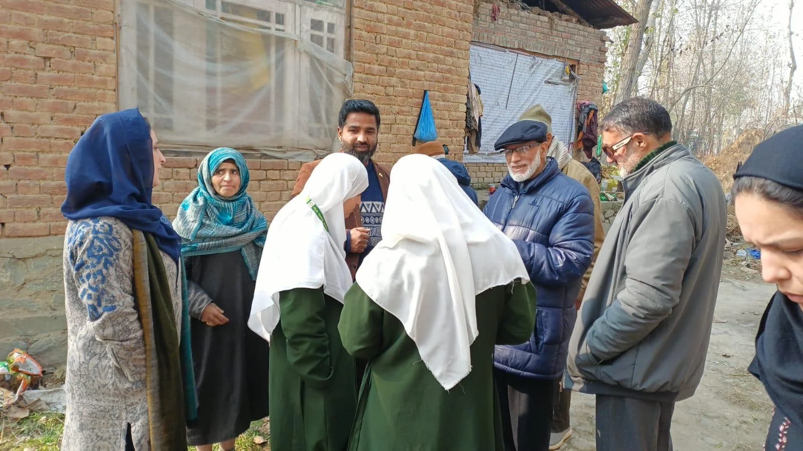SAWAB team members listening during a community field visit